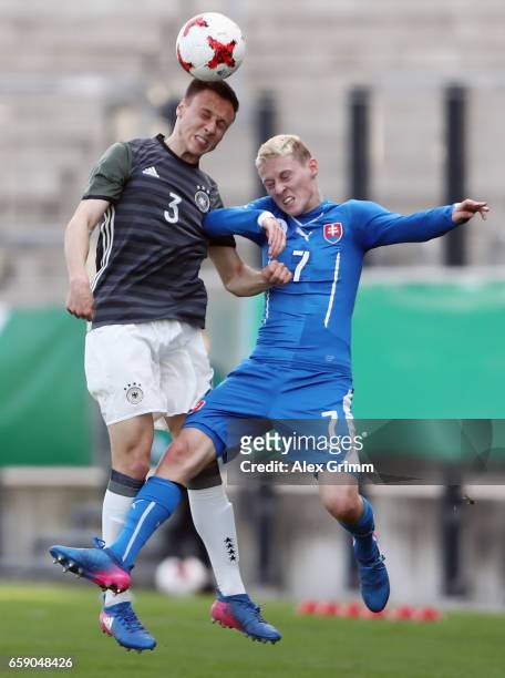 Dominik Franke of Germany jumps for a header with Simon Stefanec of Slovakia during the UEFA Elite Round match between Germany U19 and Slovakia U19...