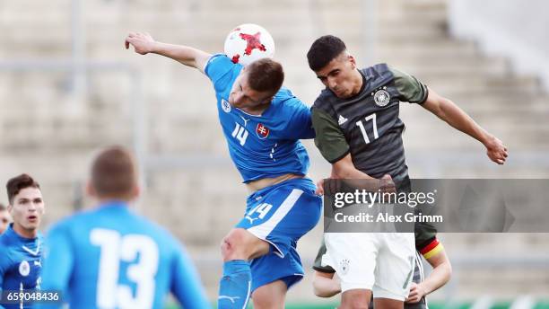 Aymen Barkok of Germany jumps for a header with Daniel Dubec of Slovakiaduring the UEFA Elite Round match between Germany U19 and Slovakia U19 at...