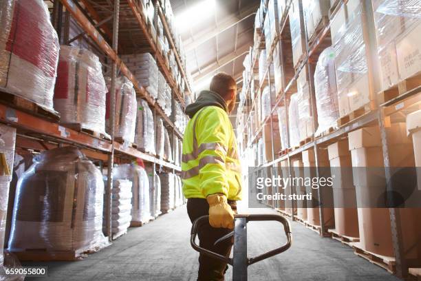 pallet jack pull - busy warehouse stock pictures, royalty-free photos & images