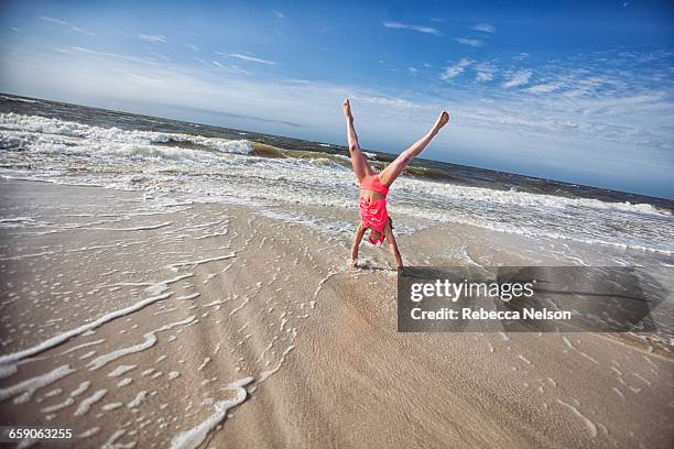 girl doing handstand on beach - mobile alabama stock pictures, royalty-free photos & images