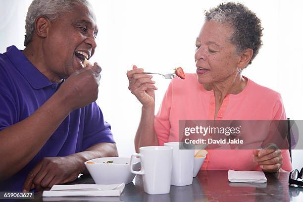 senior couple having breakfast together - david swallow stock pictures, royalty-free photos & images