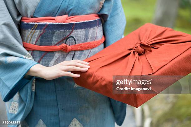 woman in kimono holding parcel - お中元 ストックフォトと画像