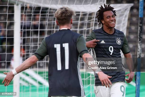 Etienne Amenyido of Germany celebrates his team's third goal with team mate Robin Hack during the UEFA Elite Round match between Germany U19 and...