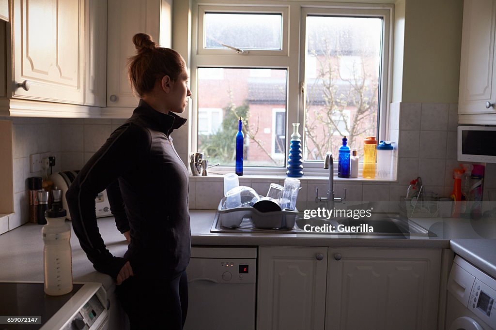 Woman At Home Preparing to Go Out For Run