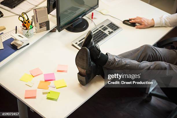 low section of a businessman feet up on desk in an office, bavaria, germany - legs on the table stock pictures, royalty-free photos & images