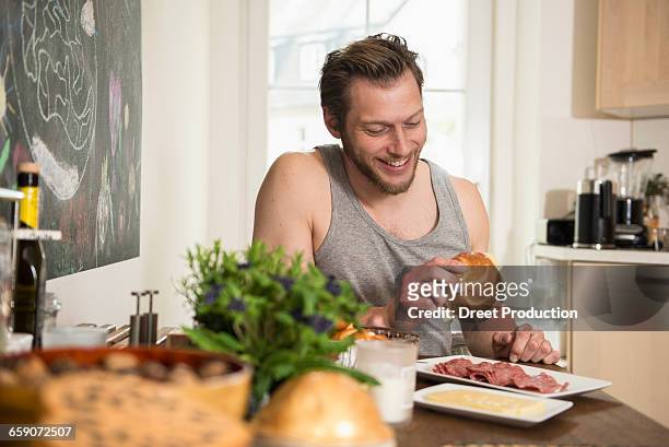 man preparing breakfast in the kitchen, munich, bavaria, germany - make room make room stock pictures, royalty-free photos & images