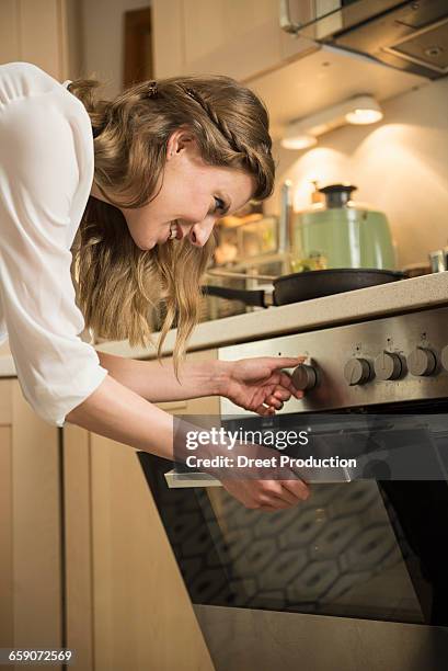 young woman working in kitchen, munich, bavaria, germany - looking back stock-fotos und bilder