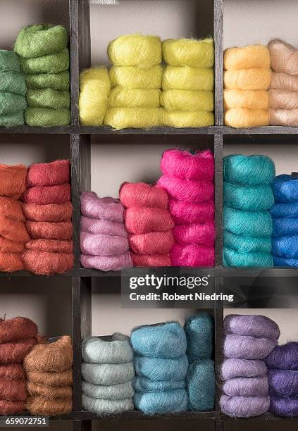 ball of wools arranging in shelf at yarn store, bavaria, germany - ball of wool stock-fotos und bilder