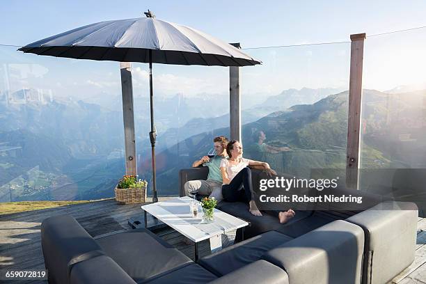 young couple drinking wine on terrace, zillertal, tyrol, austria - table front view stock pictures, royalty-free photos & images