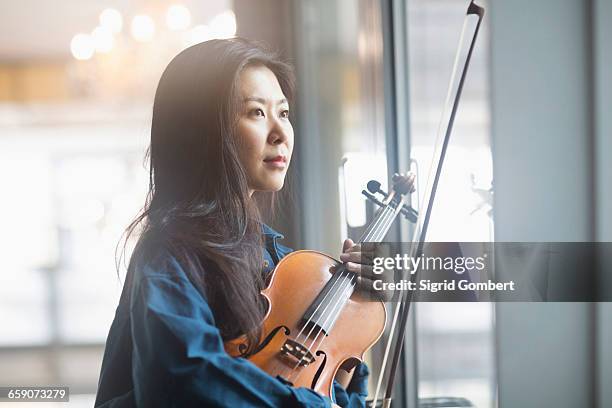 young woman playing violin, freiburg im breisgau, baden-württemberg, germany - violinist stock pictures, royalty-free photos & images