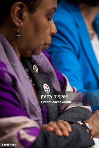 Rep. Barbara Lee wears a button supporting PBS during hearings on President Donald Trump's first budget attended by Patricia de Stacy Harrison,...