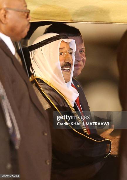 Jordan's King Abdullah II and Kuwaiti Emir Sabah al-Ahmad al-Jaber al-Sabah attend a welcome ceremony at the Queen Alia International Airport in...