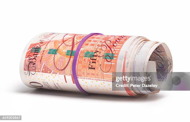 roll of uk bank notes - british pound sterling stock-fotos und bilder