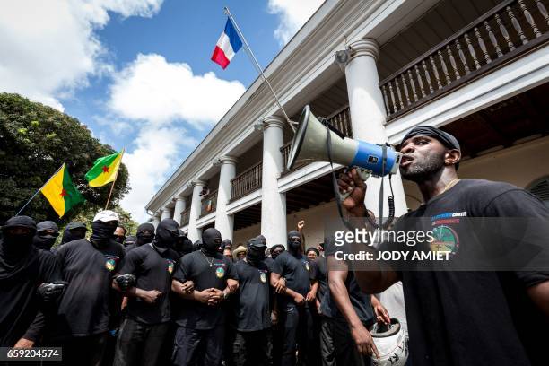 Members of The 500 Brothers group take part in a march in support of the general strike in Cayenne, on the French overseas territory of French...