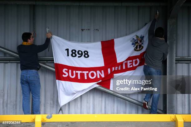 Sutton United supporters put up their teams flag prior to the Vanarama National League match between Sutton United and Lincoln City at Gander Green...