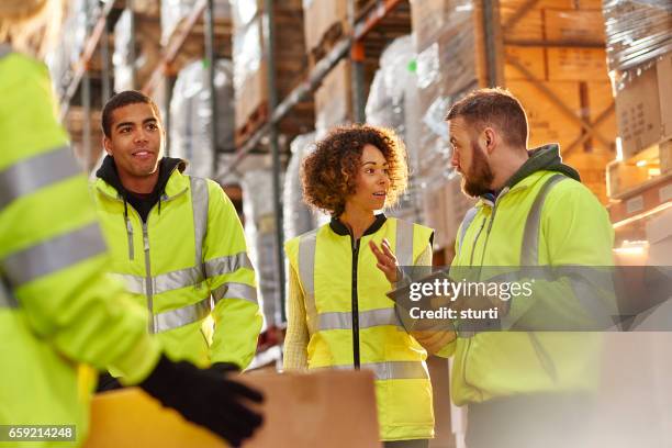 warehouse staff chat - three people working together stock pictures, royalty-free photos & images