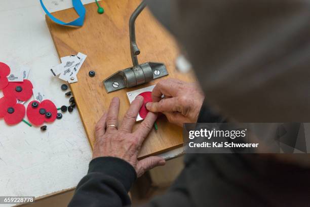 Volunteer assembles a poppy at the Royal New Zealand Returned and Services' Association Poppy Factory on March 27, 2017 in Christchurch, New Zealand....