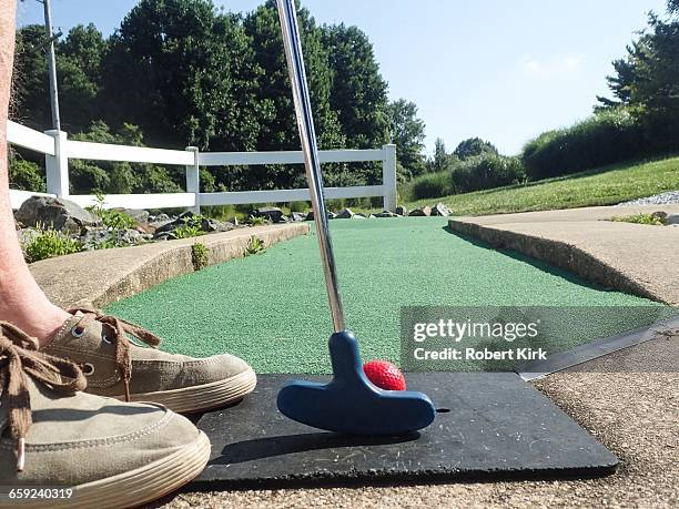 mini golf from a personal perspective - red rubber ball stock pictures, royalty-free photos & images