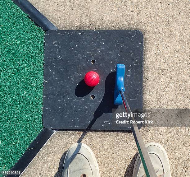 mini golf from a personal perspective - red rubber ball stock pictures, royalty-free photos & images
