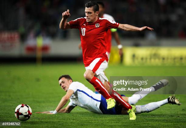 Zlatko Junuzovic of Austria is tackeld by Thomas Lam of Finland during the Austria v Finland International Friendly match at Tivoli Stadium on March...