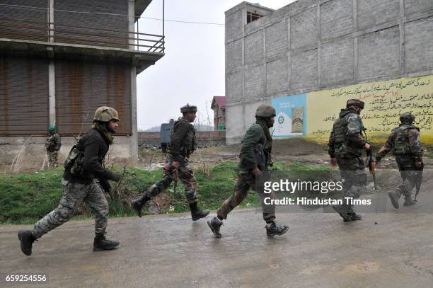 Army soldiers moving towards the site of a gun-battle in Chadoora, on March 28, 2017 in Badgam district south of Srinagar, India. One militant and...