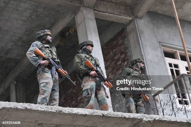 Army soldiers at the site of a gun-battle in Chadoora, on March 28, 2017 in Badgam district south of Srinagar, India. One militant and three...