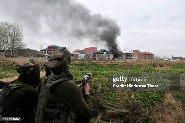 Smoke rising from the house after security forces blast the house where militant had taken refuge in Chadoora, on March 28, 2017 in Badgam district...