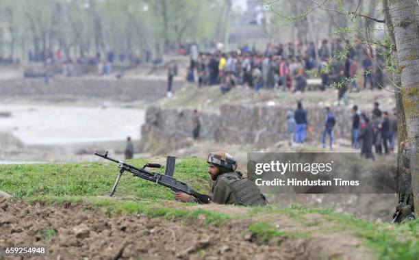 Army soldiers at the site of a gun-battle in Chadoora, on March 28, 2017 in Badgam district south of Srinagar, India. One militant and three...