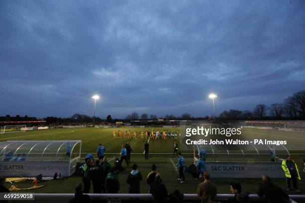 Sutton United and Lincoln City players shake hands before the start of the Vanarama National League match at Gander Green Lane, London.