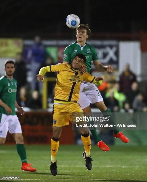 Sutton United's Maxime Biamou battles for possession of the ball with Lincoln City's Sean Raggett during the Vanarama National League match at Gander...