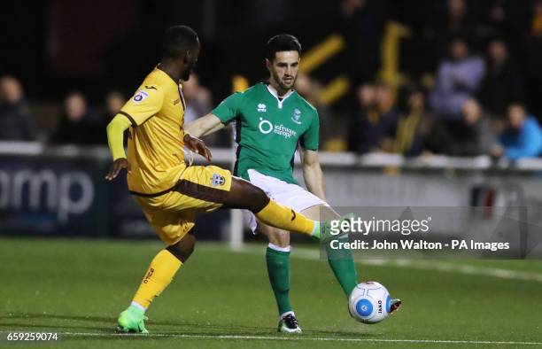 Lincoln City's Samuel Habergham, battles for possession of the ball with Sutton United's Roarie Deacon during the Vanarama National League match at...
