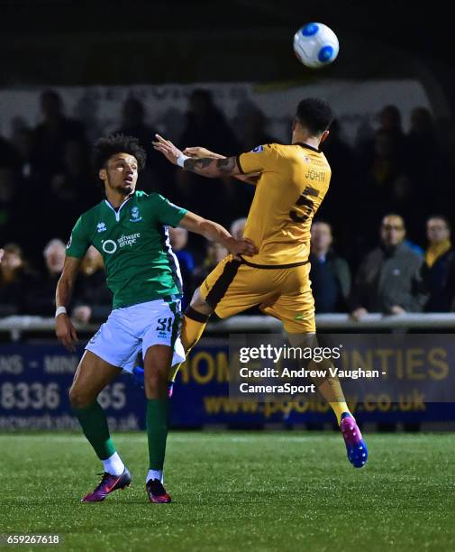 Lincoln City's Lee Angol vies for possession with Sutton United's Louis John during the Vanarama National League match between Sutton United and...