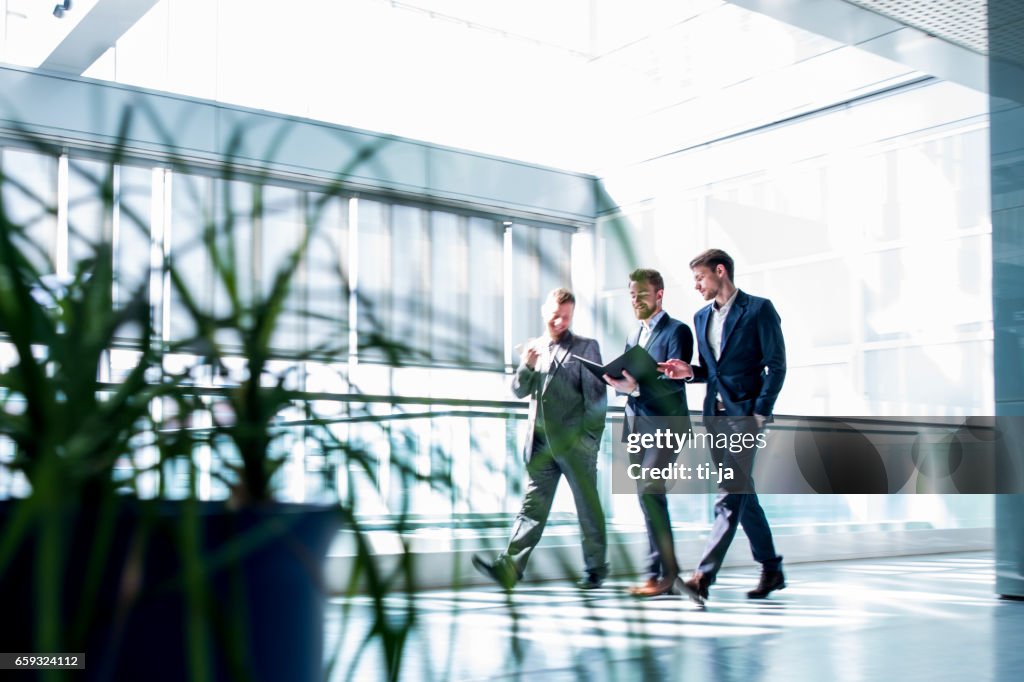 Businessmen walking in a hall