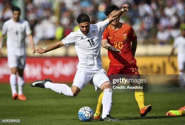 Alireza Jahan Bakhsh of Iran in action against Zhang Xizhe of China during the 2018 FIFA World Cup Qualifying group match between Iran and China at...