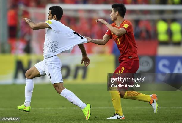 Vahid Amiri of Iran in action against Mei Fang of China during the 2018 FIFA World Cup Qualifying group match between Iran and China at Azadi Stadium...