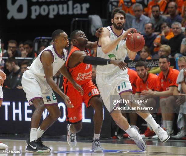 Daniel Diez, #11 of Unicaja Malaga and Kyle Fogg, #8 competes with Romain Sato, #10 of Valencia Basket during the 2016-2017 7Days Eurocup Finals Leg...