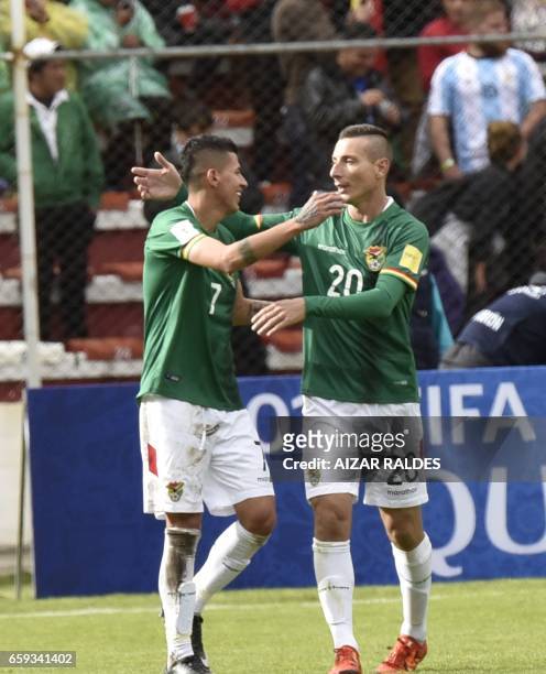 Bolivia's forward Juan Arce celebrates with Pablo Escobar after scoring against Argentina during their 2018 FIFA World Cup qualifier football match...
