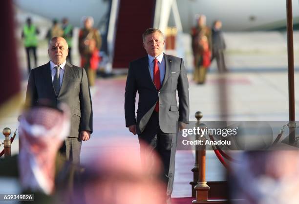 Iraqi Prime Minister Haider al-Abadi is welcomed by Jordan's King Abdullah II with an official ceremony at Queen Alia International Airport, as part...