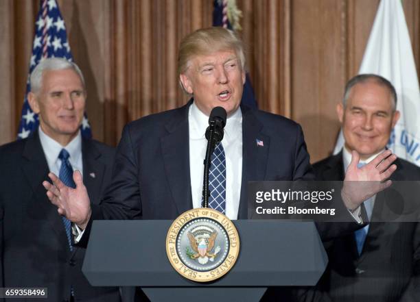 President Donald Trump, center, speaks before signing an energy independence executive order as U.S. Vice President Mike Pence, left, and Scott...
