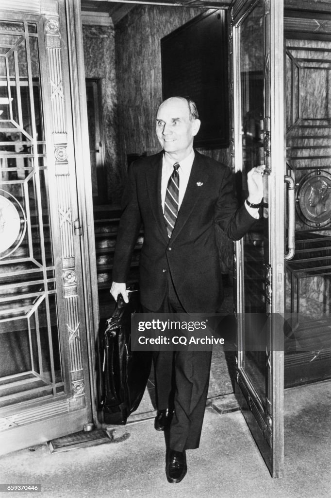 Sen. Jake Garn leaving at doorway in Bellevue