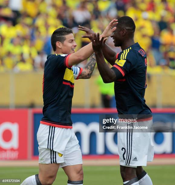James Rodríguez of Colombia celebrates with teammate Cristian Zapata after scoring the first goal of his team during a match between Ecuador and...