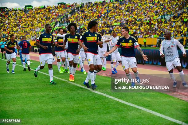 Colombia's midfielder James Rodriguez celebrates with teammates after scoring against Ecuador during their 2018 FIFA World Cup qualifier football...