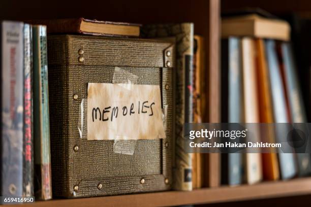 memories box in book shelf - souvenirs stock-fotos und bilder