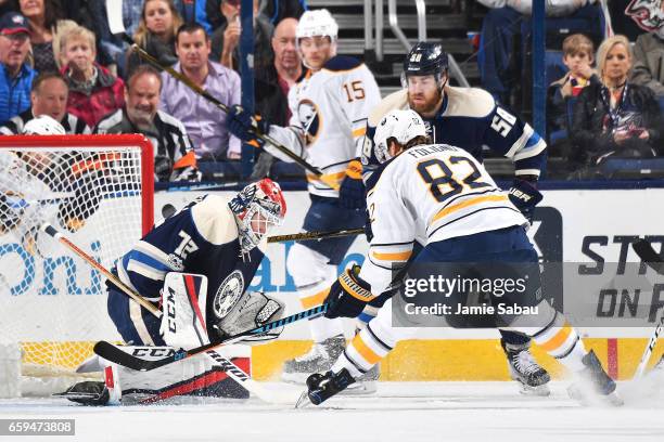 Goaltender Sergei Bobrovsky of the Columbus Blue Jackets freezes the puck as Marcus Foligno of the Buffalo Sabres and David Savard of the Columbus...