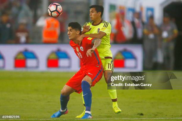 Pedro Pablo Hernandez of Chile fights for the ball with Renzo Zambrano of Venezuela during a match between Chile and Venezuela as part of FIFA 2018...