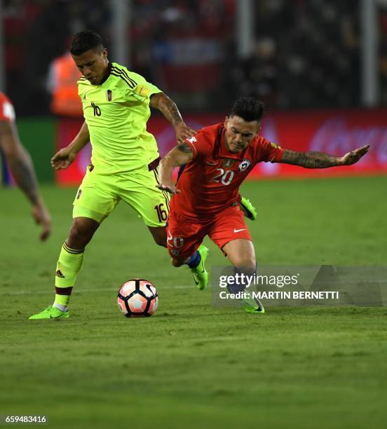 Chile's Charles Aranguiz vies for the ball with Venezuela's midfielder Darwin Machis during their 2018 FIFA World Cup qualifier football match in...