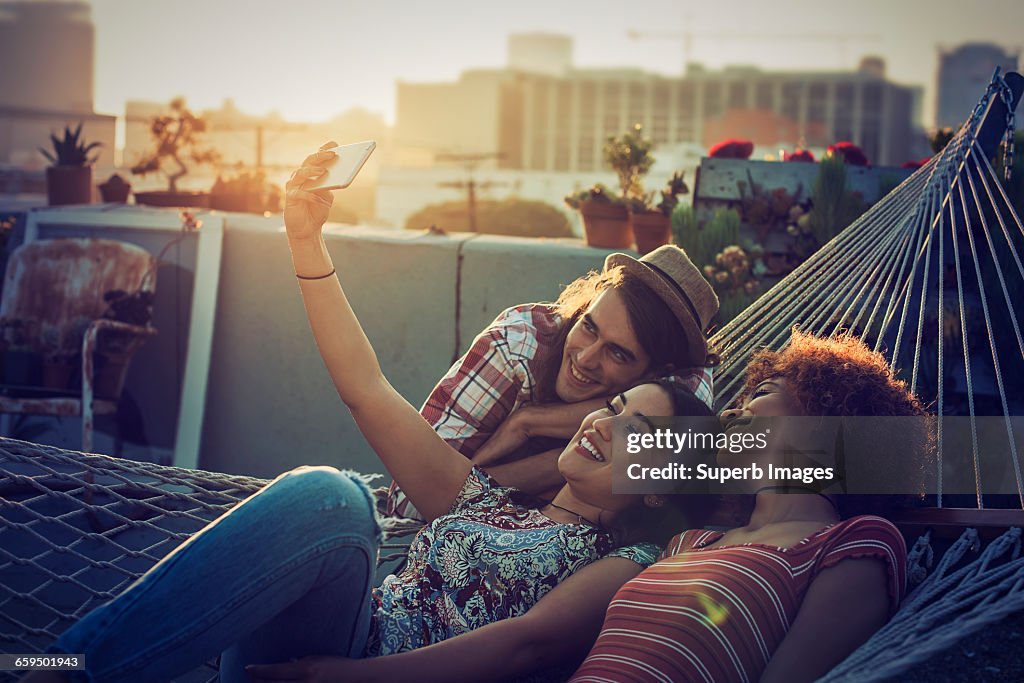 Friends taking a selfie on urban rooftop