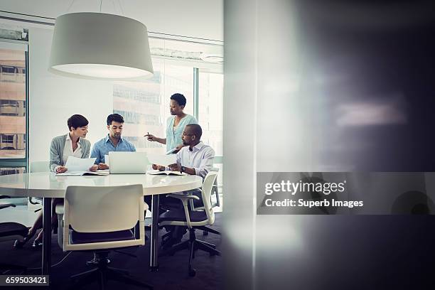 business meeting in office - four people and meeting stock pictures, royalty-free photos & images