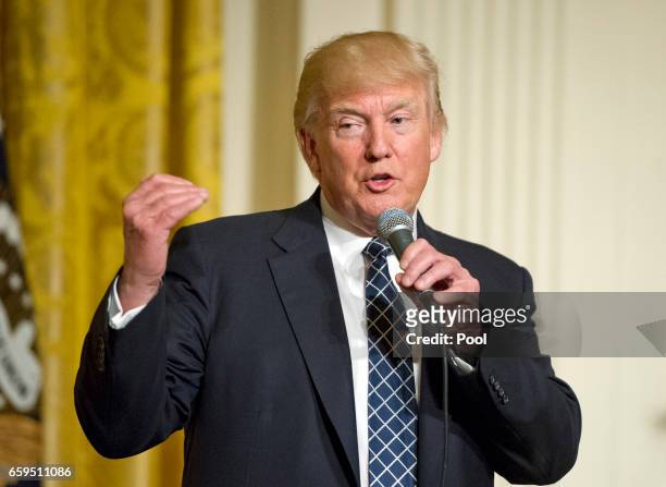 President Donald Trump makes remarks at a reception for U.S. Senators and their spouses in the East Room of the White House on March 28, 2017 in...
