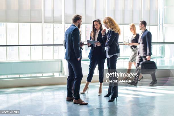 business discussion - people talking in office corridor stock pictures, royalty-free photos & images